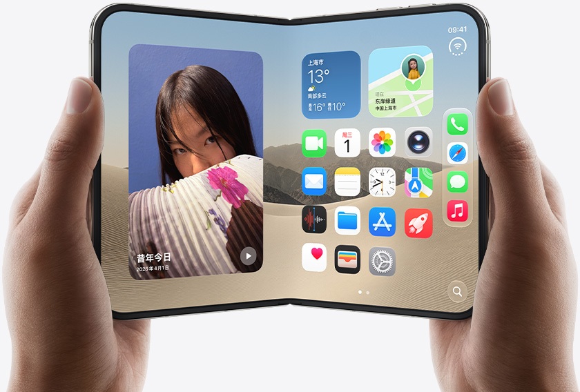 两只手拿着展开的 iPhone Duo,左侧界面显示一张女子照片,右侧界面显示主屏幕画面,其中包含信息、照片、相机和 App Store 等多种 app 图标。